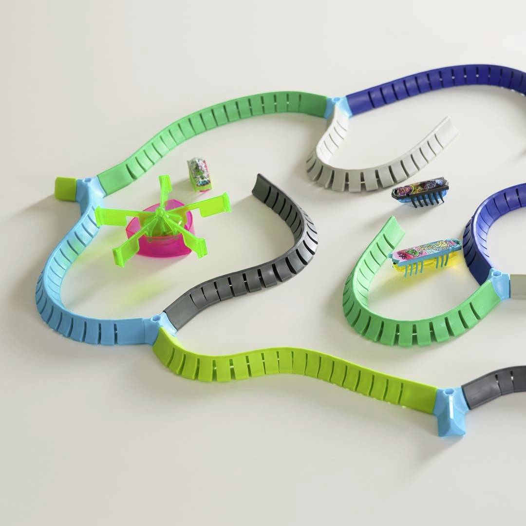 Toy helicopter and colourful plastic tracks on a white background. The tracks are arranged in various shapes and colours.