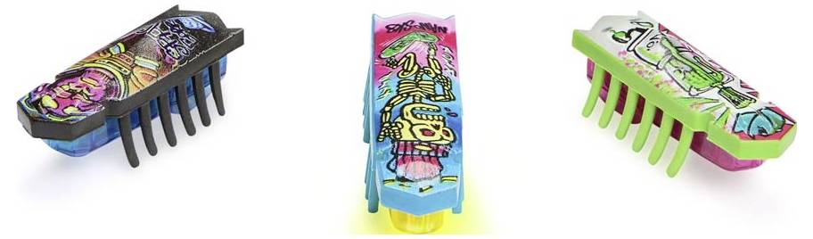 Three colourful Hexbug Nano robots with various patterns on a white background, each with six flexible legs.