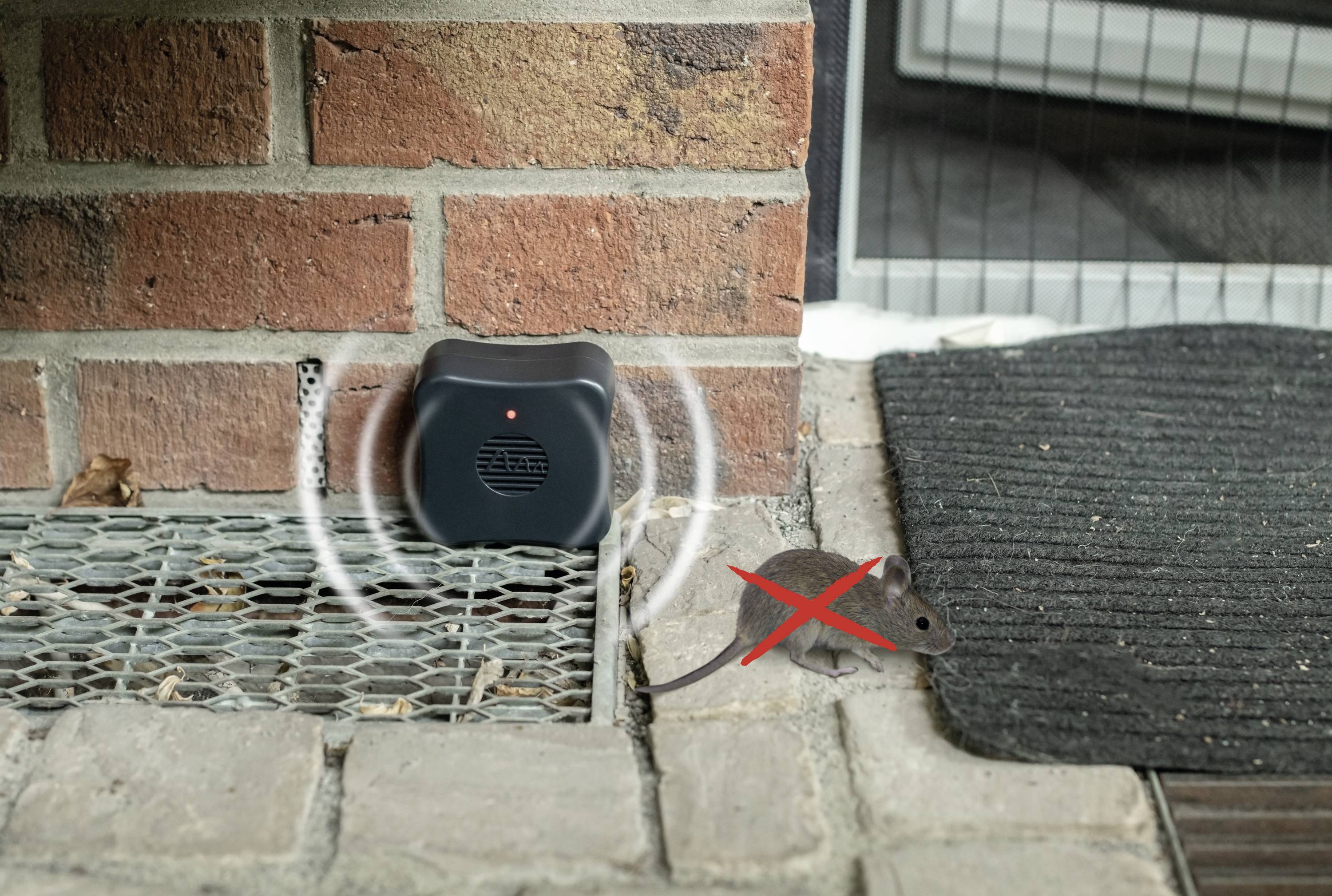 An ultrasonic pest repeller next to a brick wall, emitting sound waves, with a mouse marked with a red X.