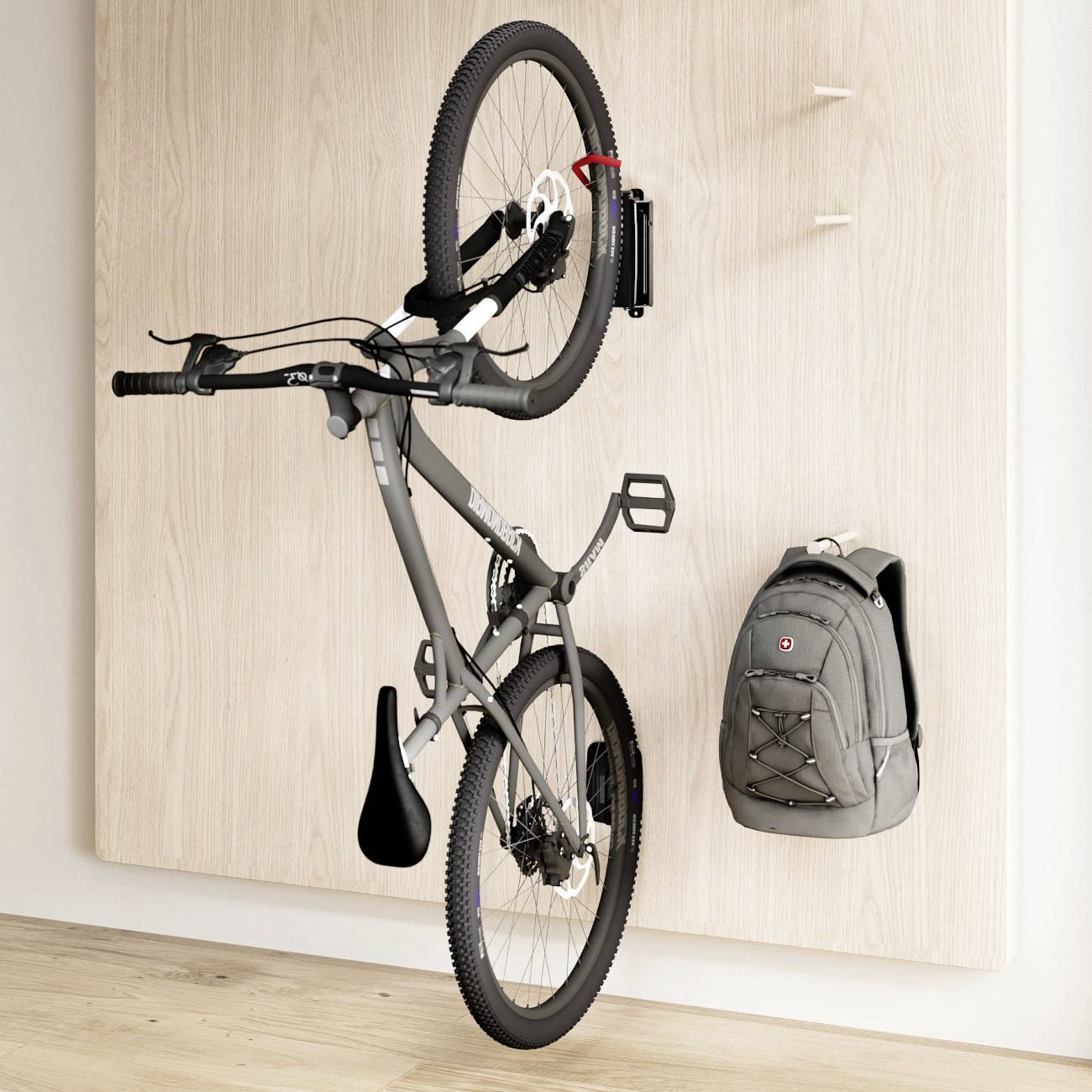 A bicycle and a grey rucksack are hanging side by side on a light wooden board mounted on the wall.