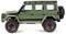 A green model car with a Jeep design, raised suspension, rugged tyres, spare wheel at the rear, red alloy wheels. Side view.