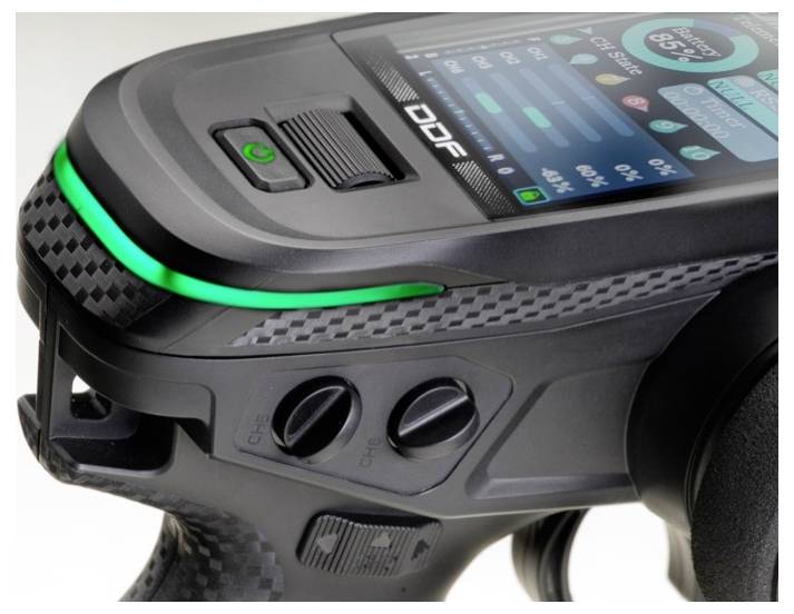 A black, futuristic hand controller with a display and illuminating green stripe. Suitable for remote control or gaming.