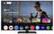 A television displays the Google TV interface. 'Oppenheimer' is recommended, surrounded by other app icons such as Netflix and Disney+.