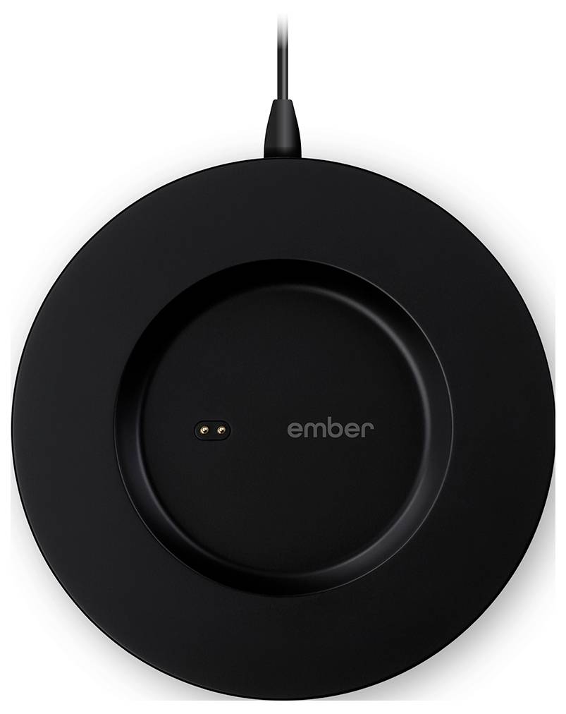 A round, black charging pad with a cable on top. The word 'ember' is written in light grey text in the centre.