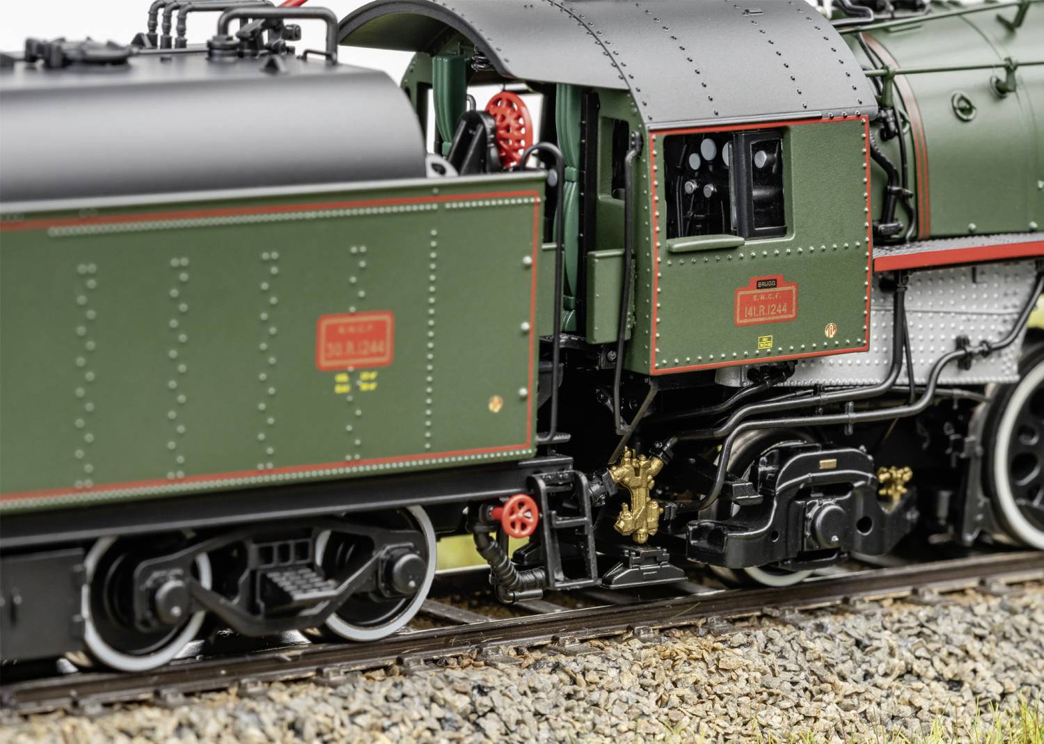 A model train on a track shows detailed elements such as wheels and signage in a close-up shot.