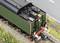 Model steam locomotive with green paintwork and a detailed water tank on a section of railway track.