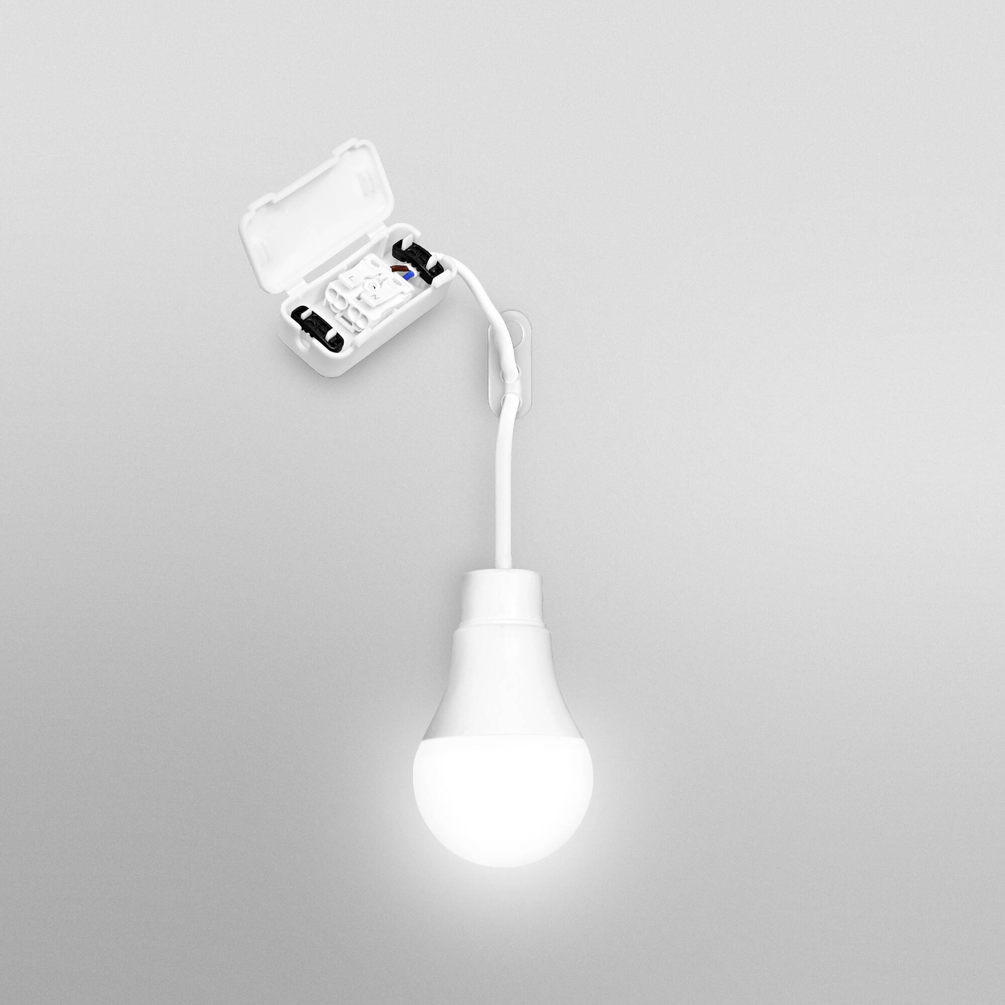 A white, glowing light bulb hangs from the ceiling. Above, an open casing with electronic components is visible.
