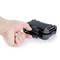 A hand is pressing on a black, rectangular mechanism that looks like a latch or a holding device.