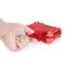 A hand presses on a red, transparent box, which is being closed.