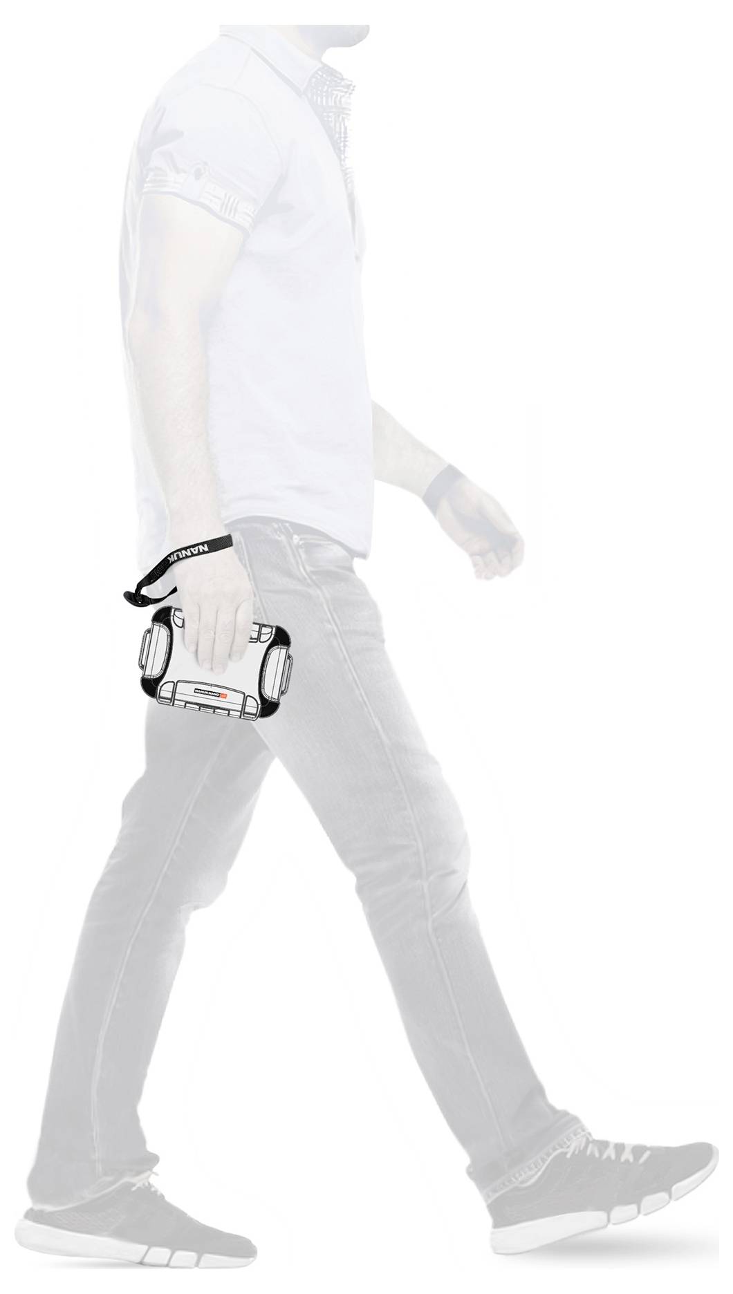 A person is walking with a compact camera in their right hand. The camera has a distinctive design and is worn on the wrist.
