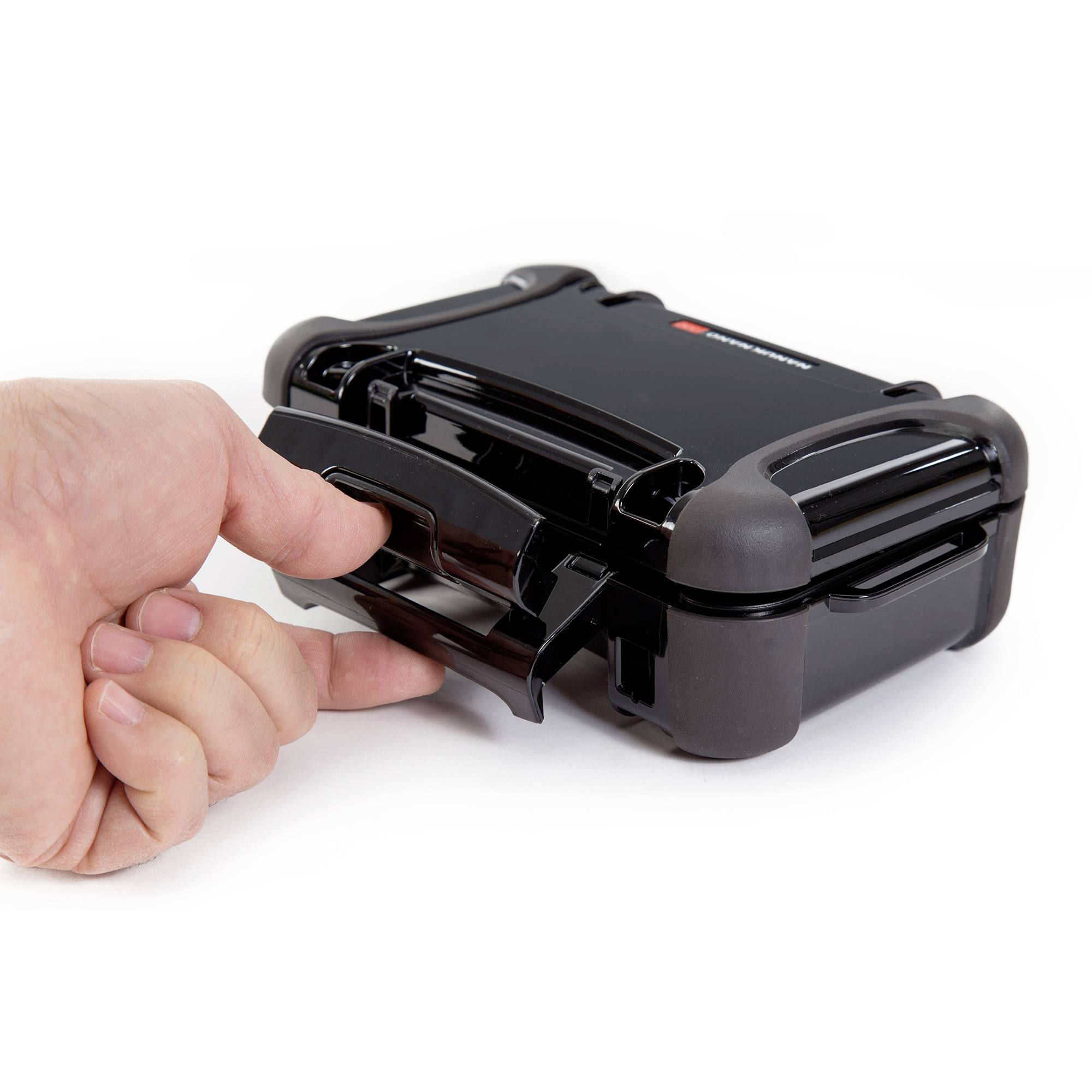 A thumb pulls at a black suitcase with sturdy edges.