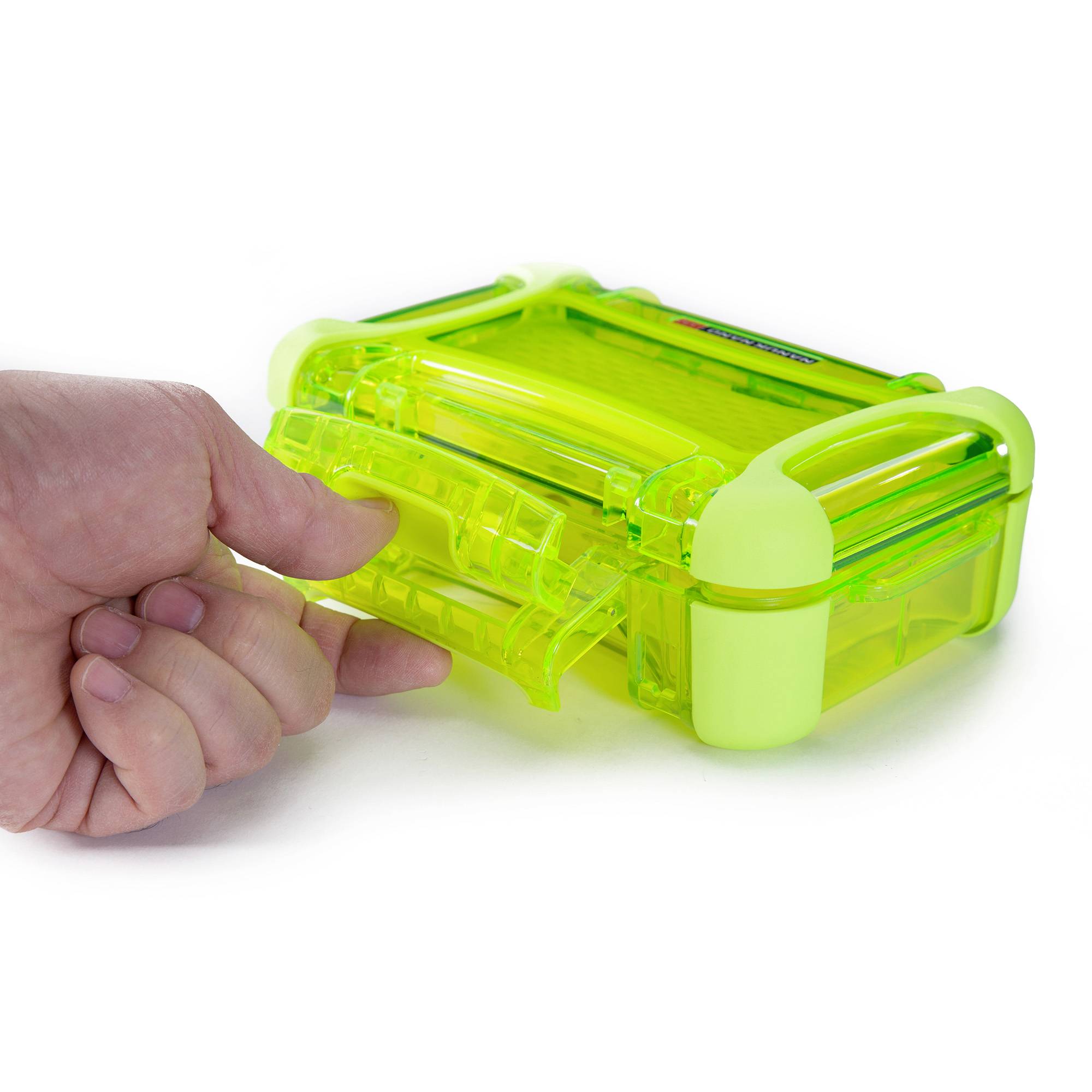 A hand opens a green, transparent, small plastic suitcase.