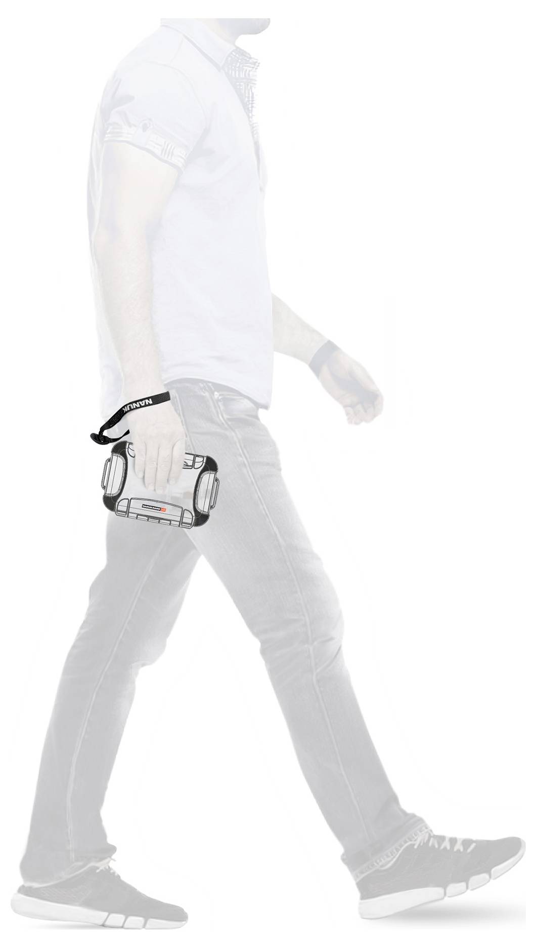 A person is walking sideways holding a portable device in their hand. The device has a wrist strap and resembles a portable speaker.