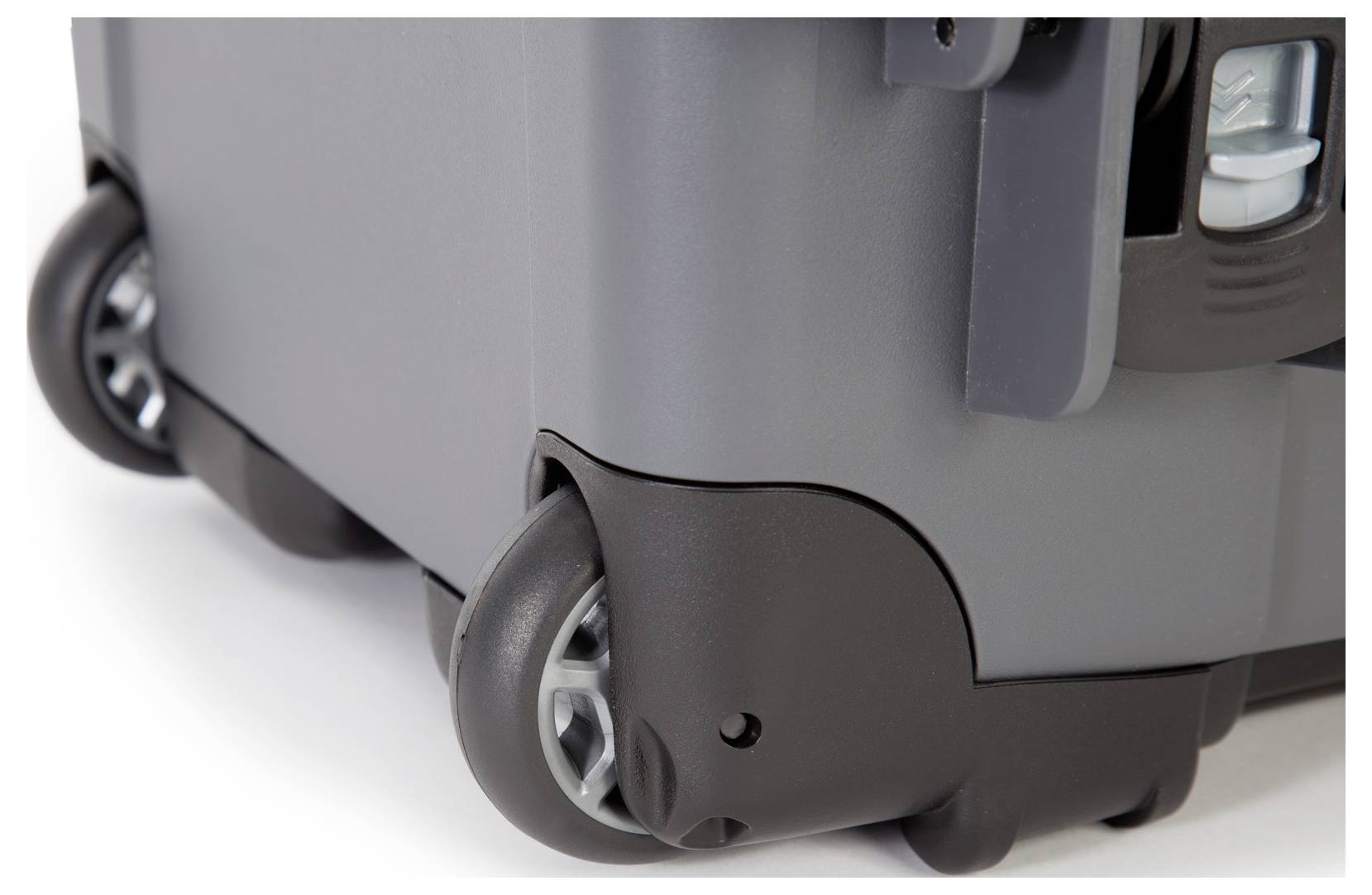 A grey suitcase with rounded corners and wheels for easy mobility.