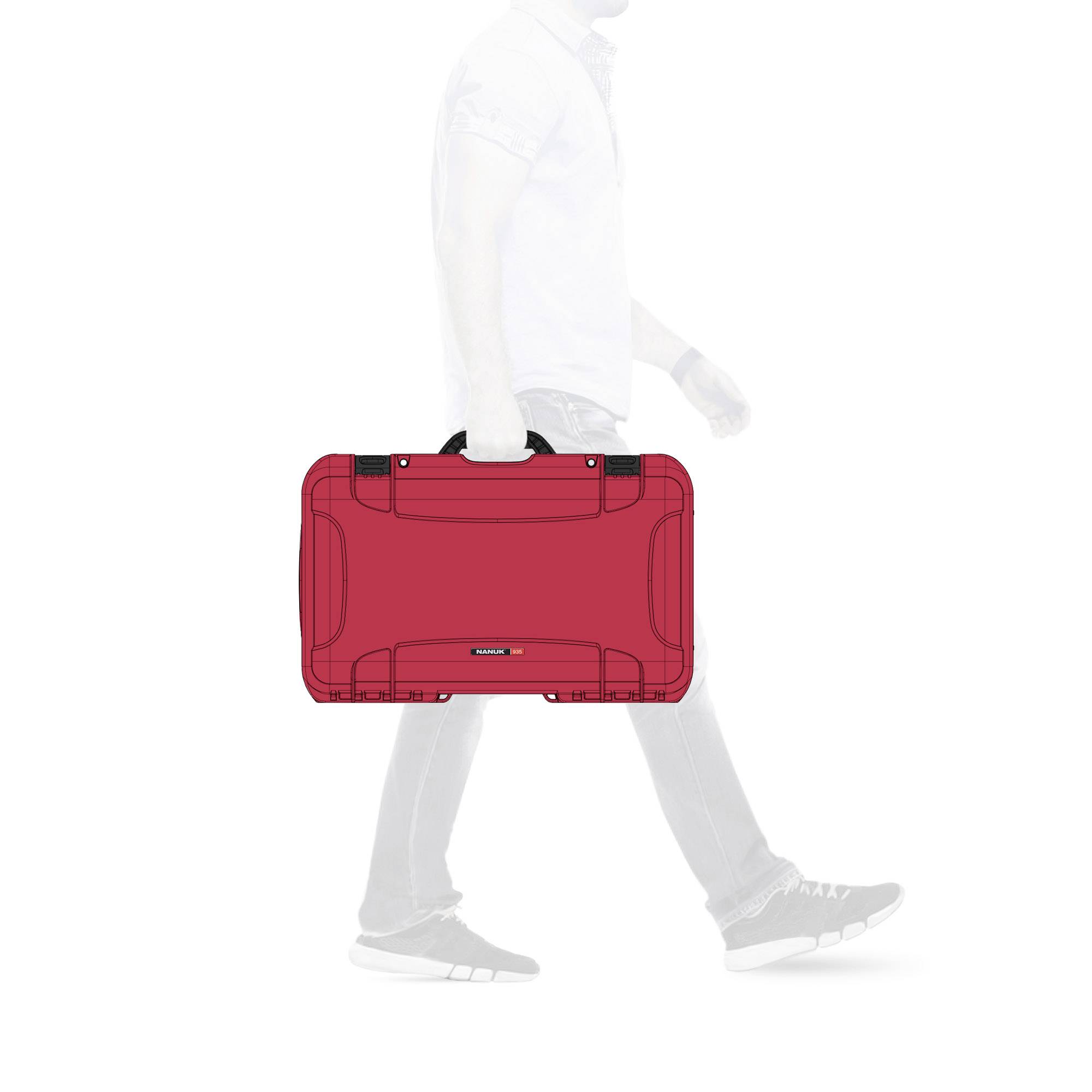Side view of a person, holding a red suitcase, walking to the right. Focus on the suitcase. Background blurred.