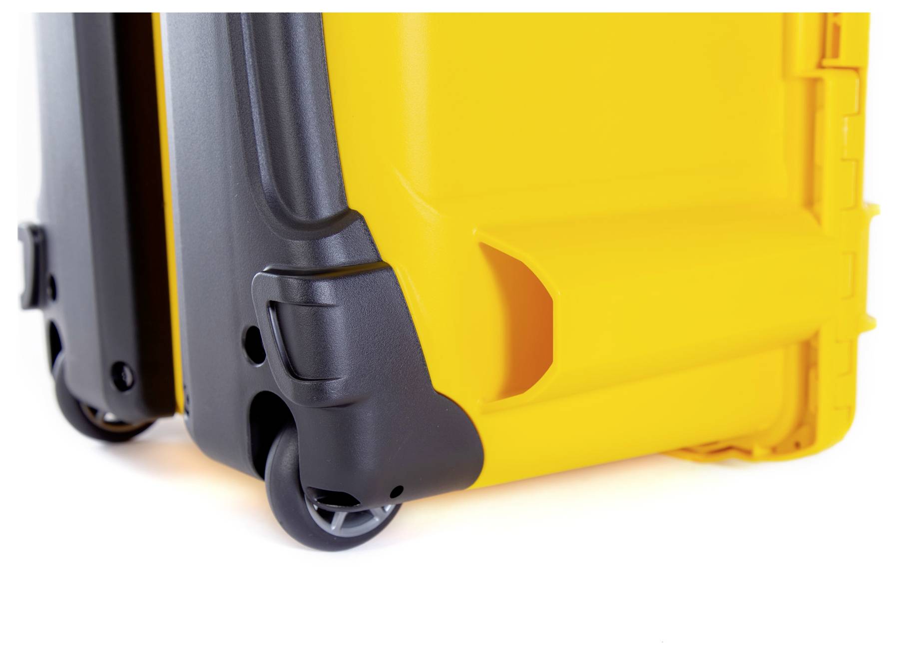 Close-up of a yellow hard-shell suitcase with black wheels in motion.
