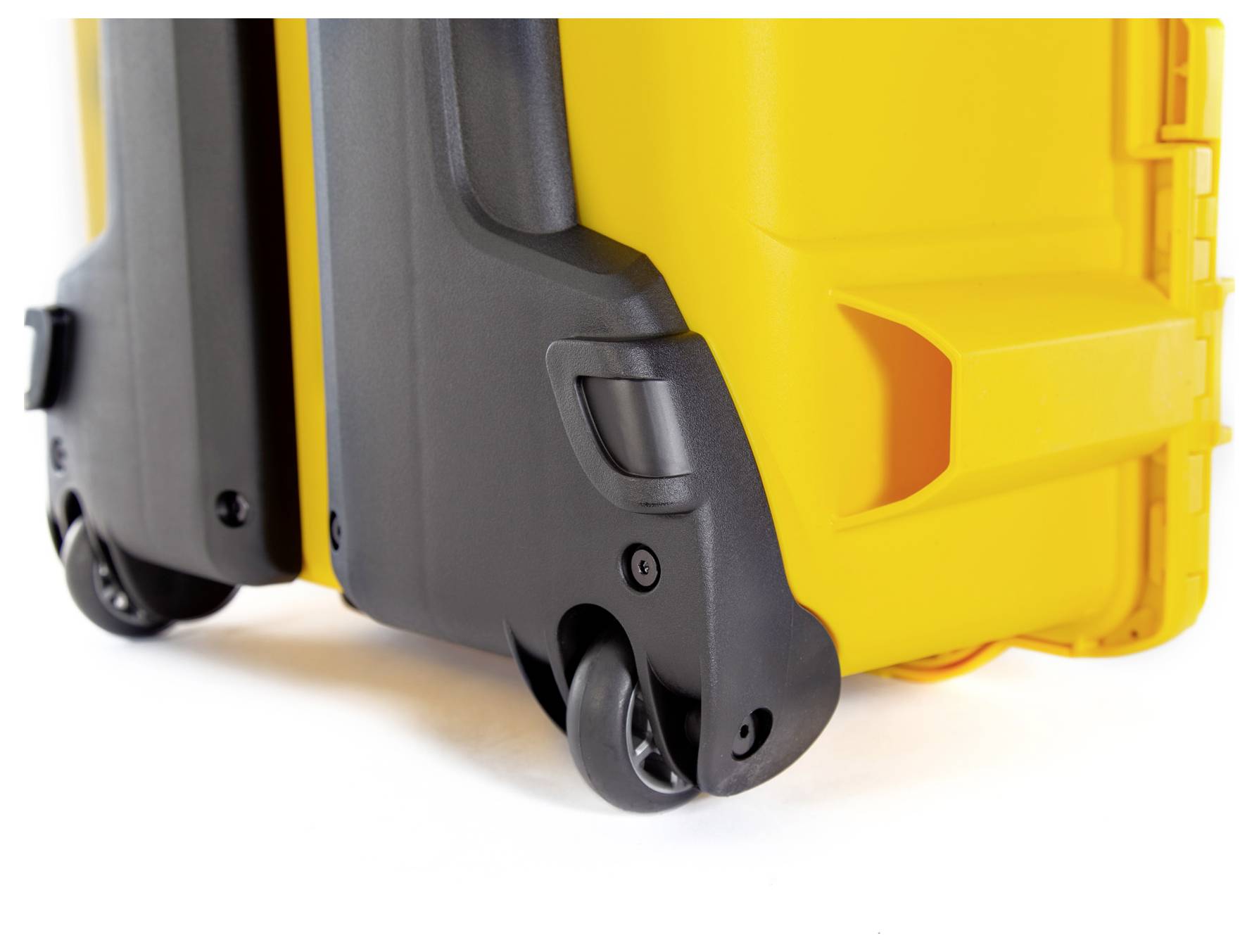 A yellow suitcase with black wheels and handle, shot in close-up. Right side of the suitcase visible, focusing on the details of the wheels.