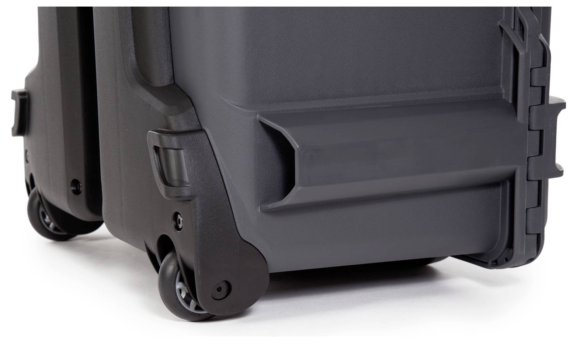 Black hard-shell suitcase on wheels in close-up, showing sturdy, robust castors and a smooth surface, emphasising mobility and durability.