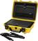 A yellow transport case with an open lid reveals a secure, padded interior. A shoulder strap lies beside it.