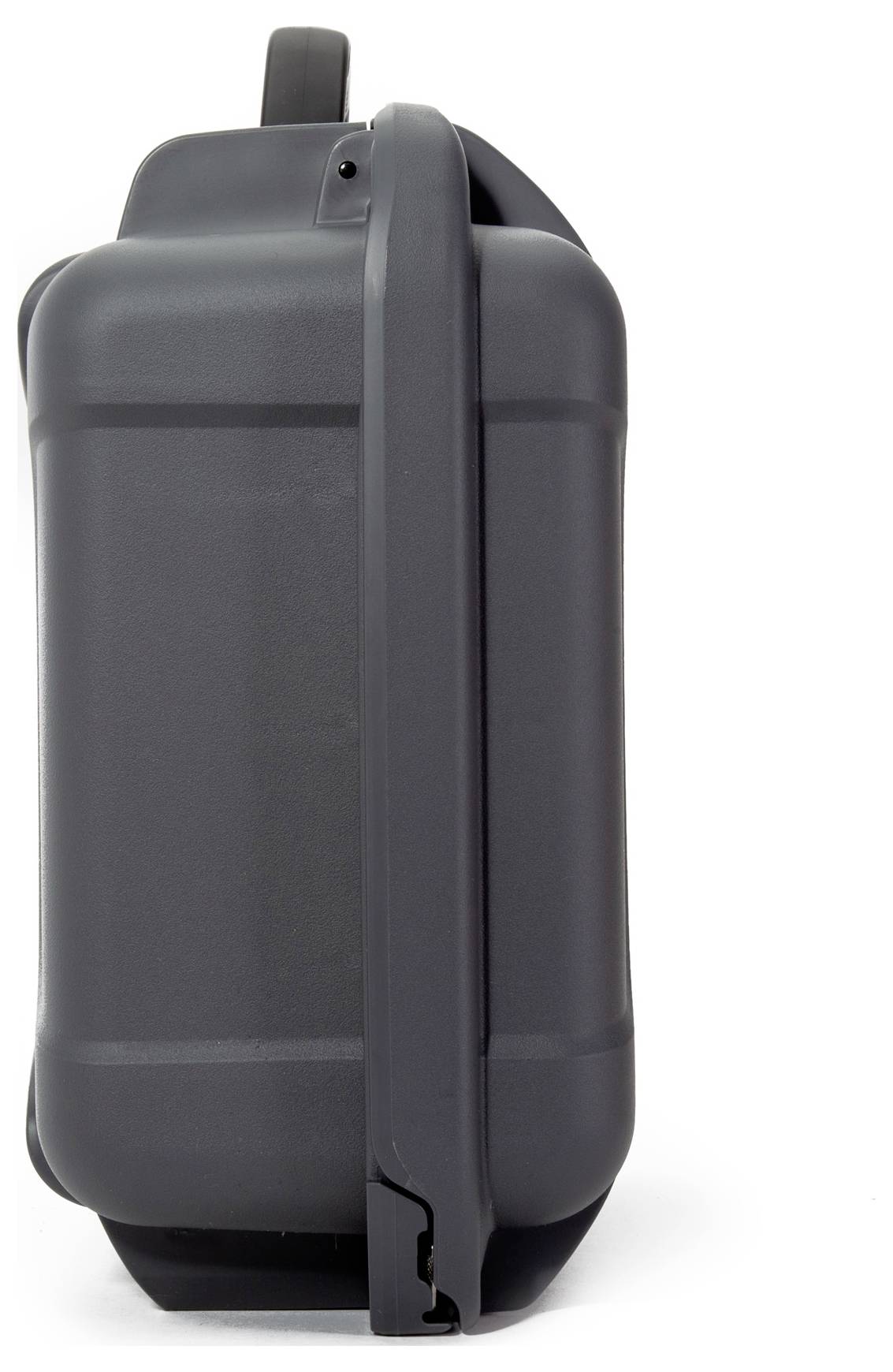 A black suitcase stands upright, photographed from the side. It has a handle at the top and wheels at the bottom, suitable for travelling.