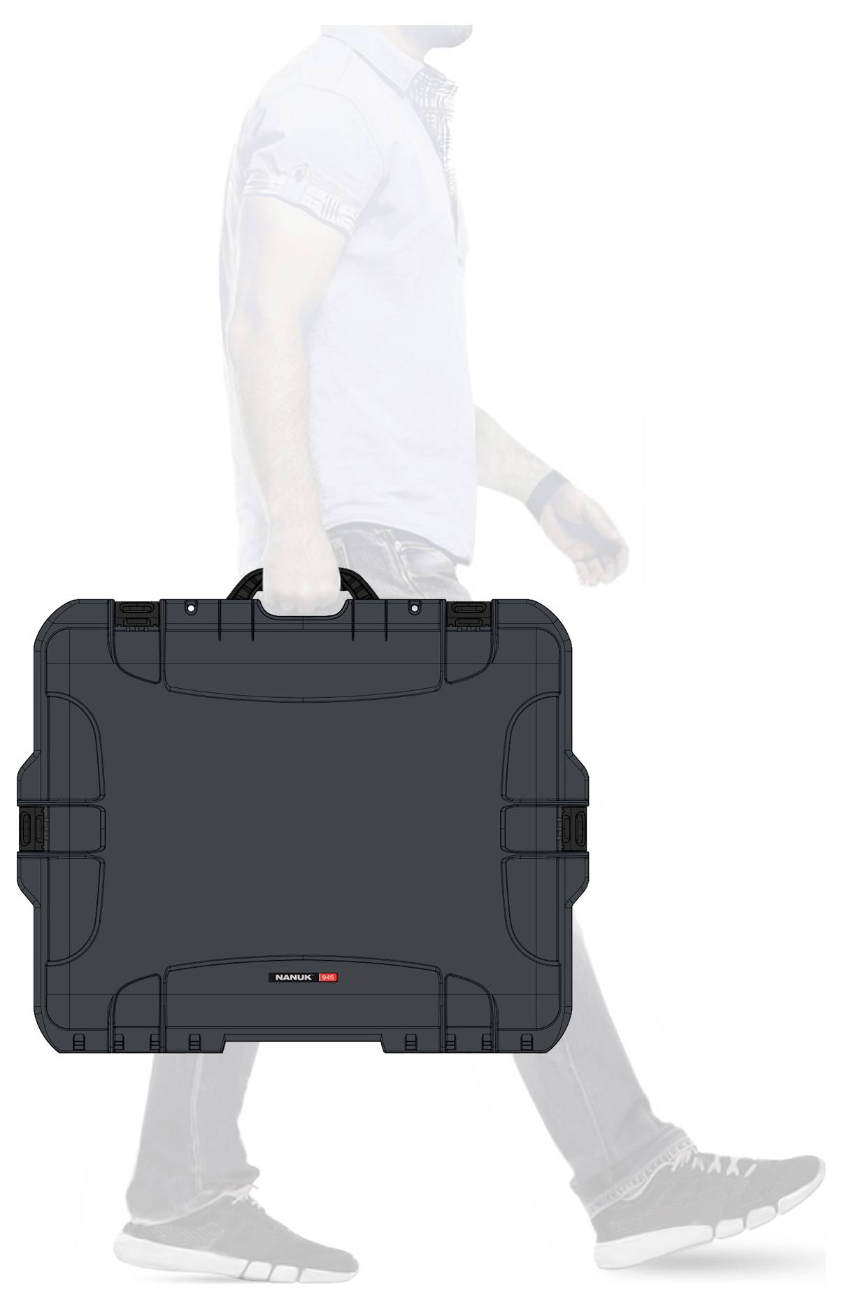 A person is carrying a large black suitcase in their hand. The suitcase has a robust design and rounded corners. The individual is visible from the side.