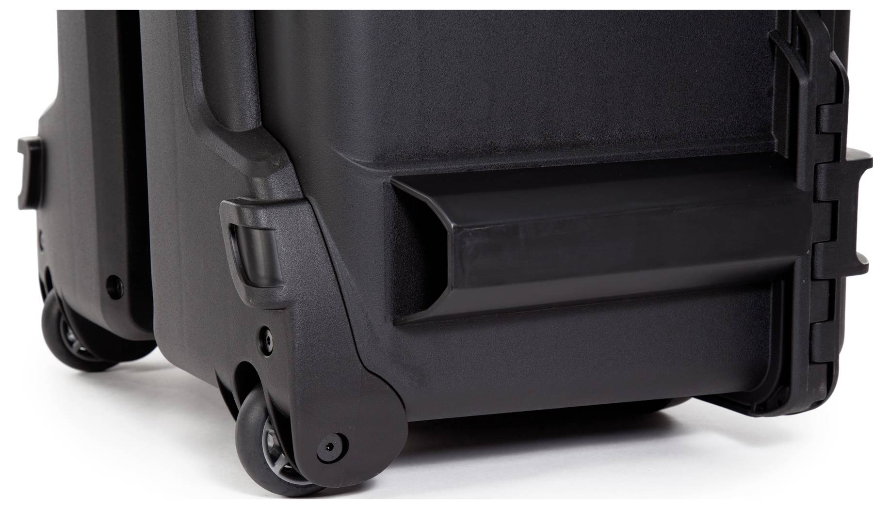 Black suitcase with wheels in close-up. Suitcase has robust construction and side handles. Suitable for travel or transport.