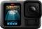 A GoPro camera displays on the screen an image of a diver swimming through an underwater cave system.