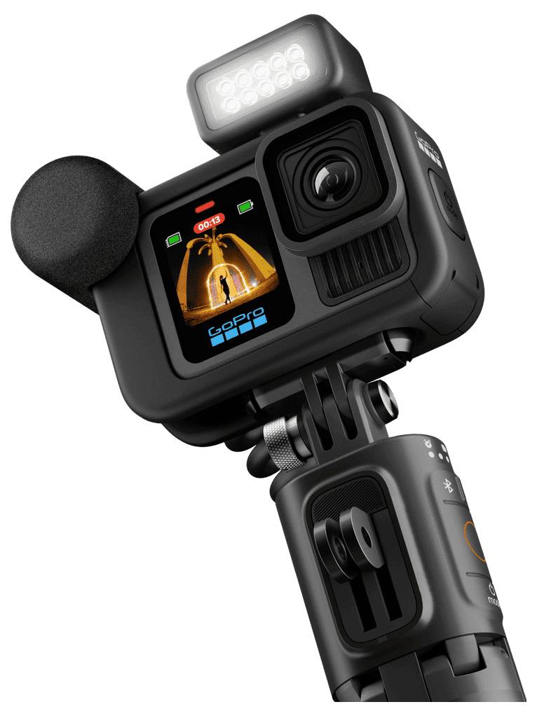 Digital camera with microphone and LED light, mounted on a tripod. Front view shows display with recording indicator.