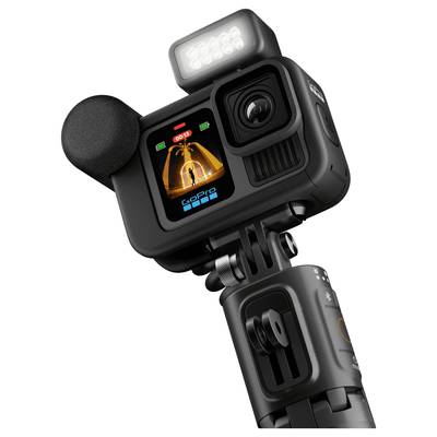 Digital camera with microphone and LED light, mounted on a tripod. Front view shows display with recording indicator.