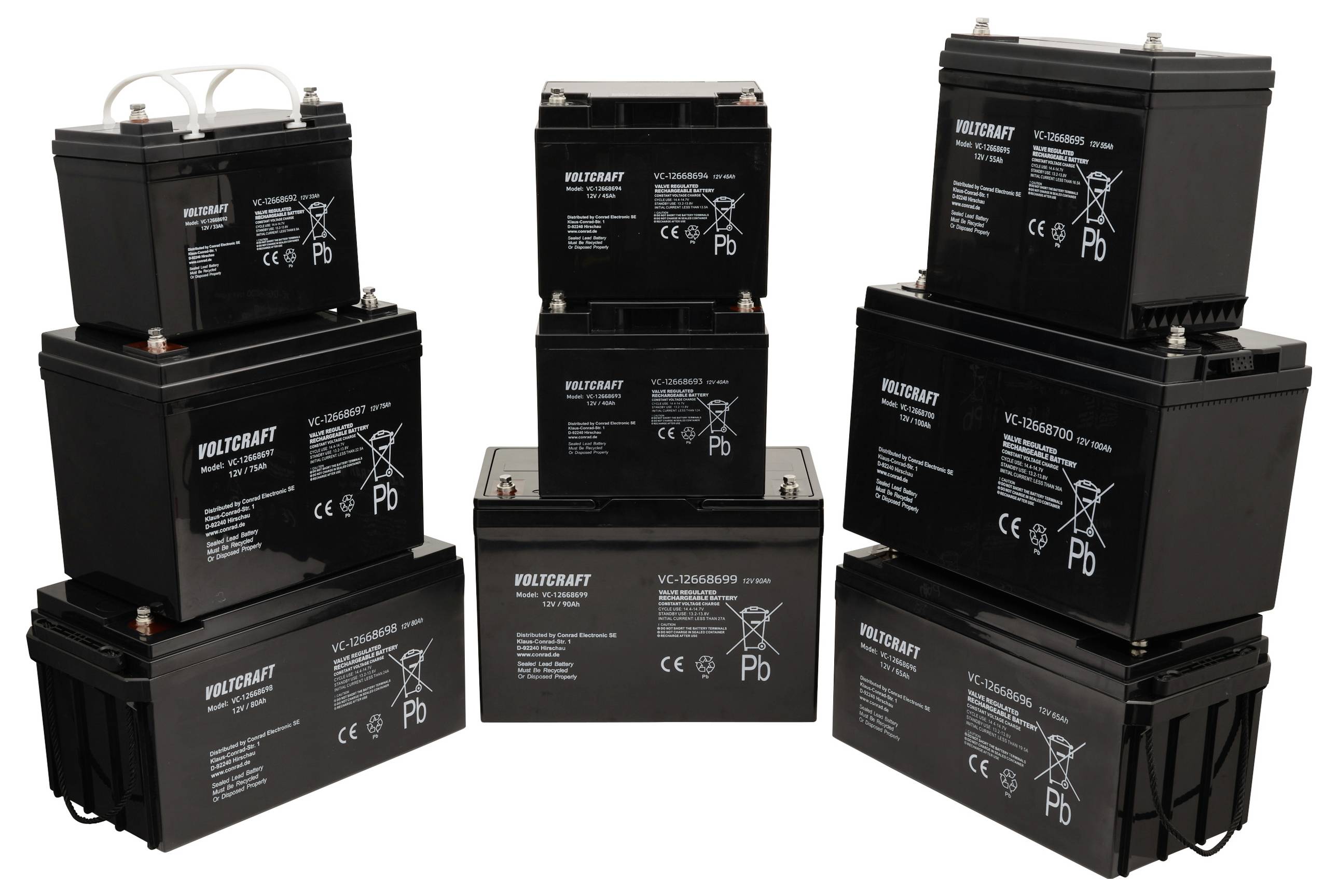 Several black batteries of different sizes are stacked. Each battery bears the inscription 'VOLTCRAFT'.