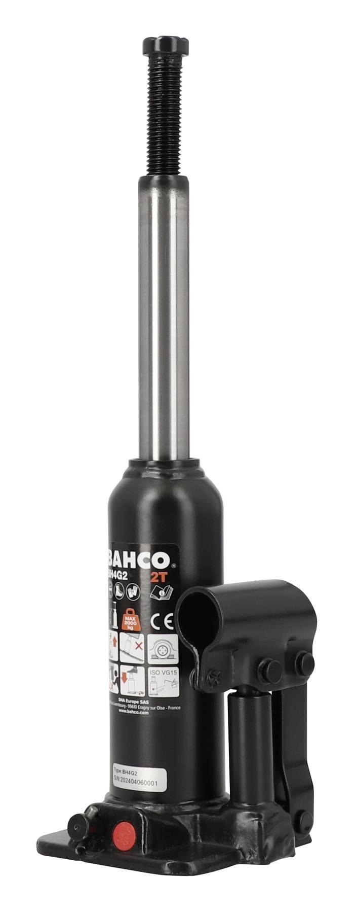 A black hydraulic jack with a silver lever, standing upright, with warning notices on the front.