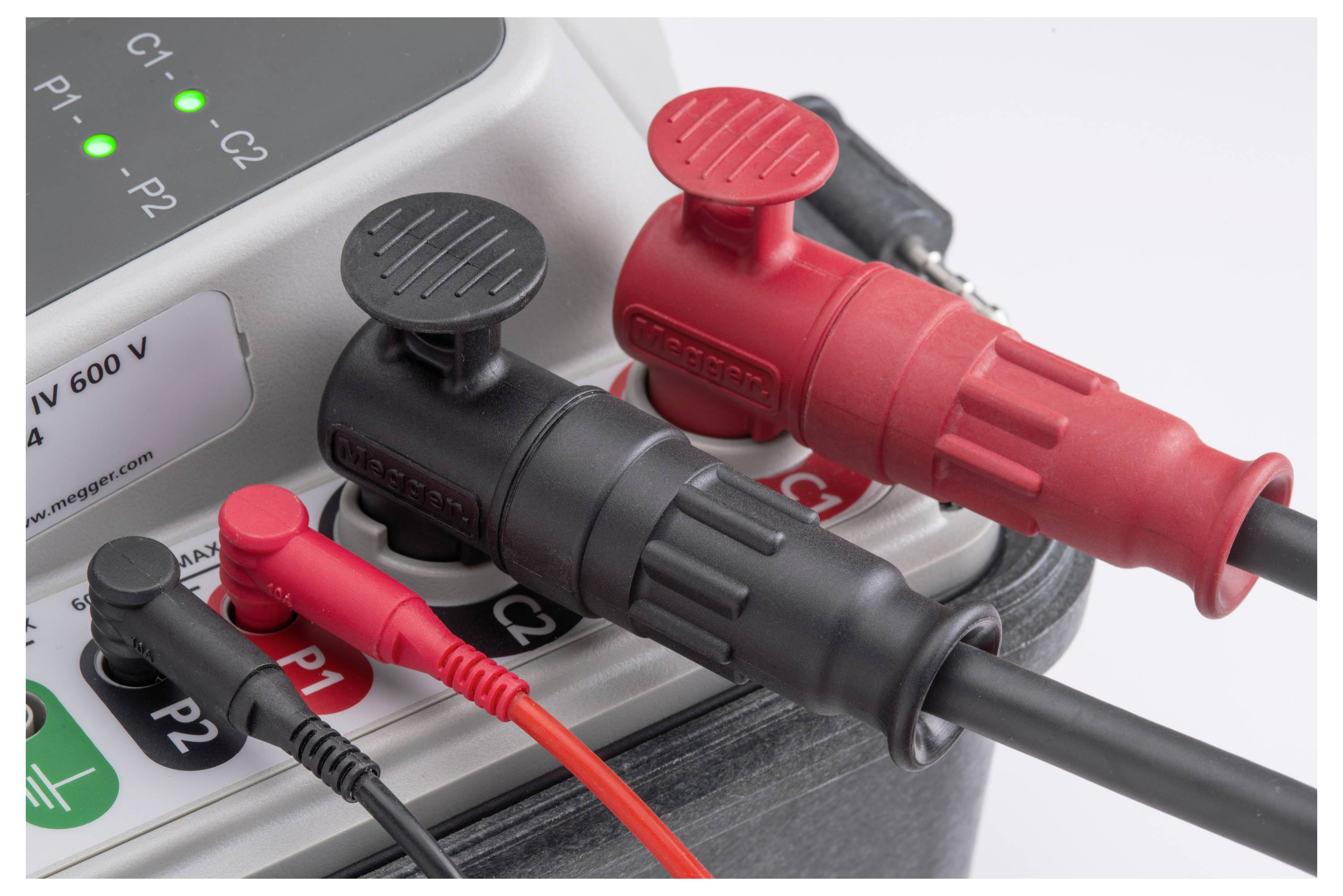 Close-up of multiple coloured cable connections on an electronic device. Red and black plugs are visible.