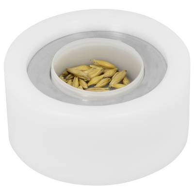 White cylindrical container with a recessed opening holding a small pile of grain or seeds.<br>