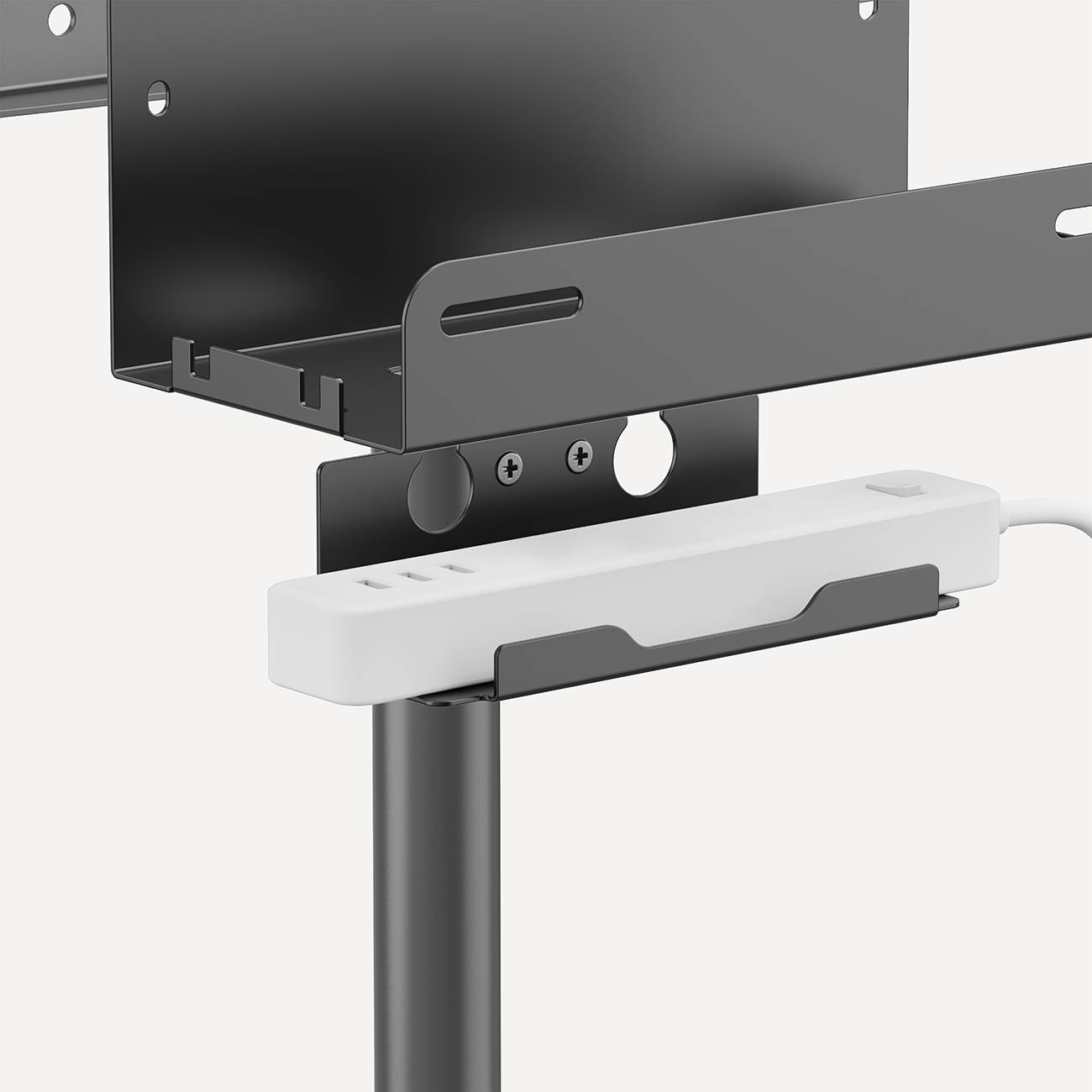 A black metal component with slots and holes is mounted on a white stand. It may serve as a TV mounting bracket.