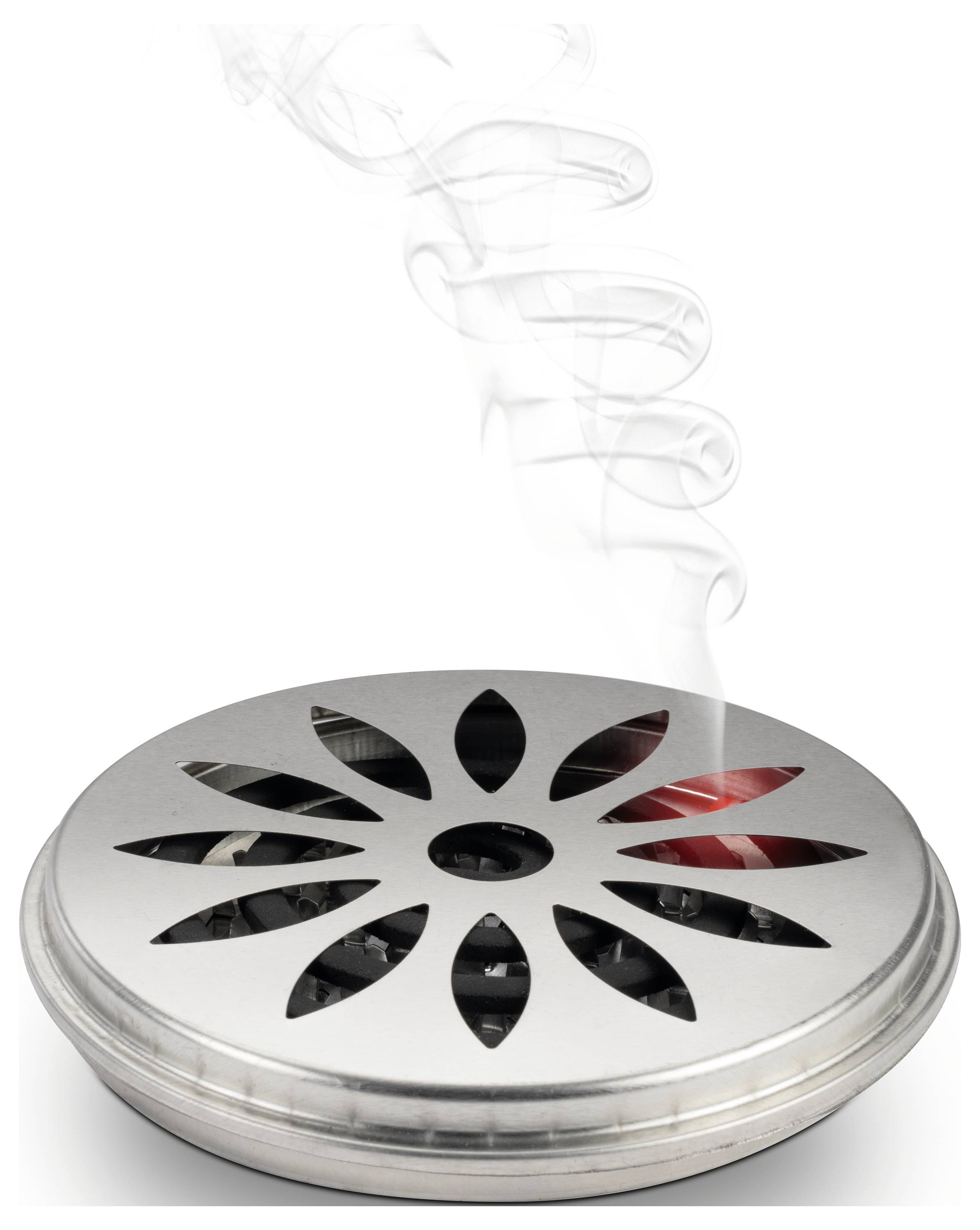 Metal round fragrance diffuser from which smoke rises. Suitable for dispersing fragrances in rooms.<br><br>Translation to British English:<br>Metal round air freshener with rising smoke. Ideal for dispersing scents throughout interior spaces.