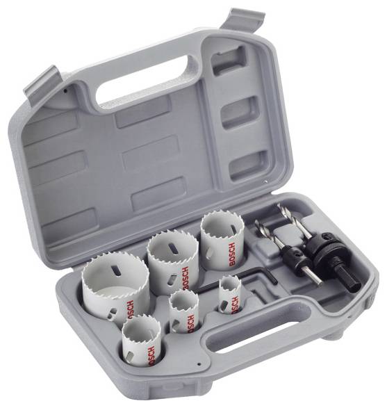 A grey toolbox containing six white hole saws and a drill bit. The hole saws are arranged in various sizes.