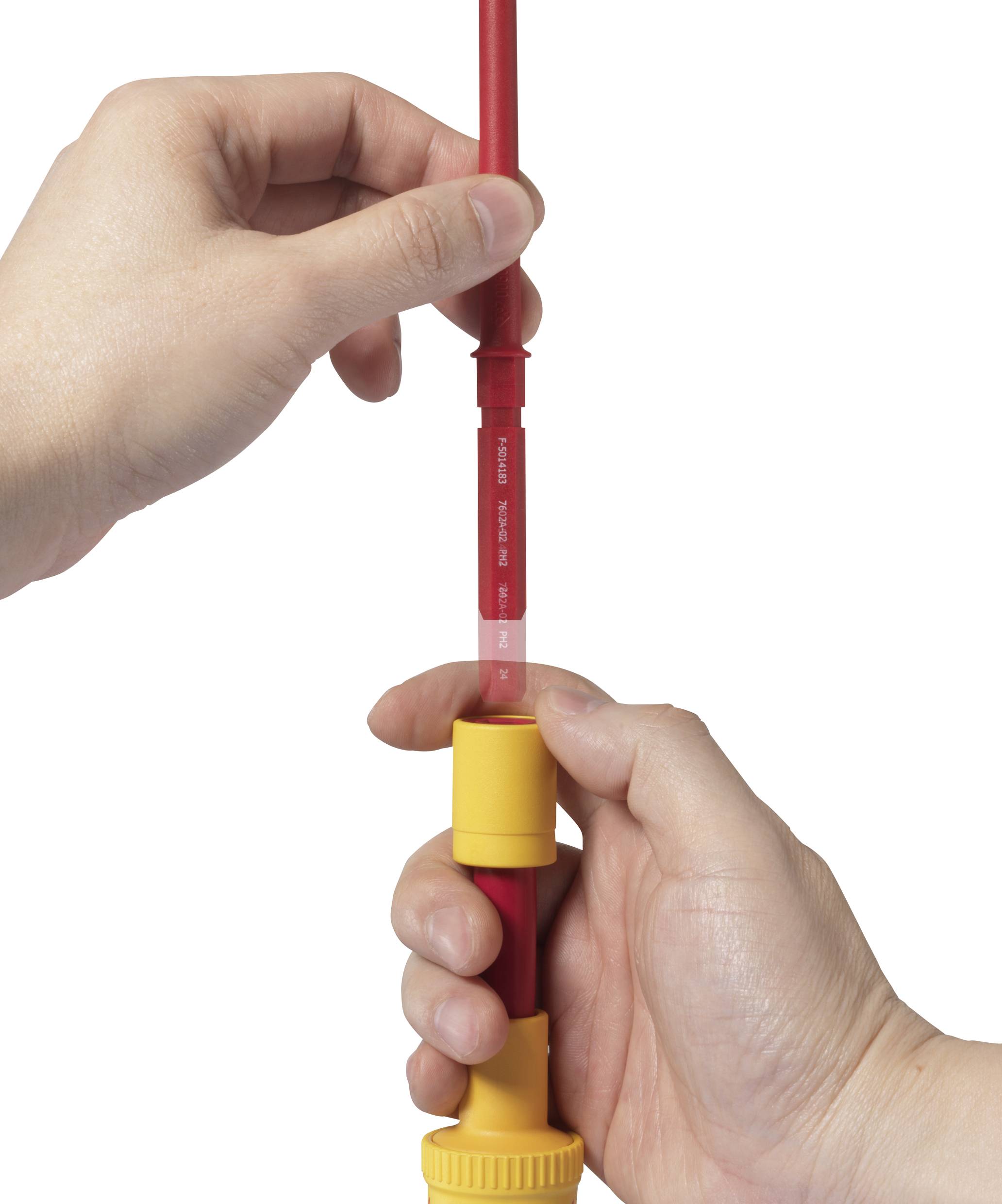 A person is holding a red pipe with one hand at the top and securing it with a yellow clamp in the other hand.