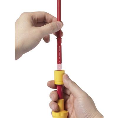 Hands hold and open a Stabokehülle by pulling a red rod out of a yellow casing.