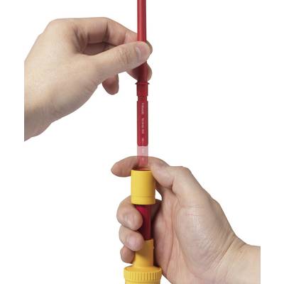 'Close-up of two hands holding and adjusting a red pipe with a yellow cap.'