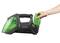 'A hand holding a green, portable vacuum cleaner with a removable filter. The device has an ergonomic handle and modern design.'