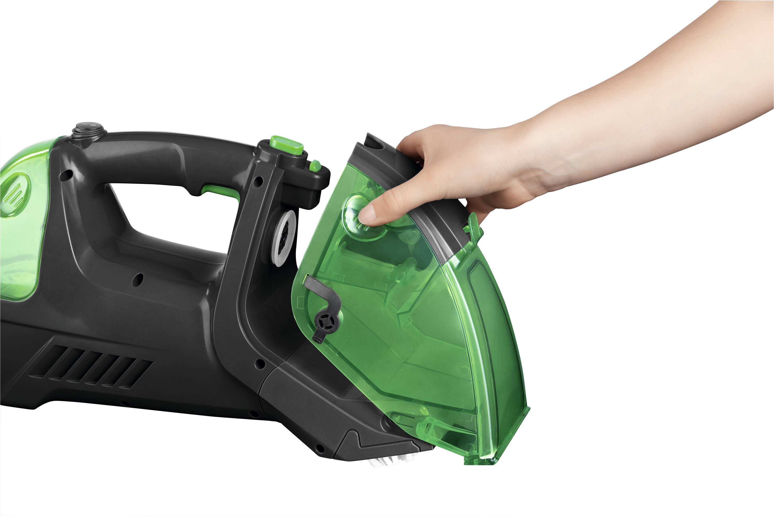 A person removes the green dirt container from a handheld vacuum cleaner. The vacuum cleaner is black and suitable for small cleaning tasks.