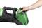 A person removes the green dirt container from a handheld vacuum cleaner. The vacuum cleaner is black and suitable for small cleaning tasks.