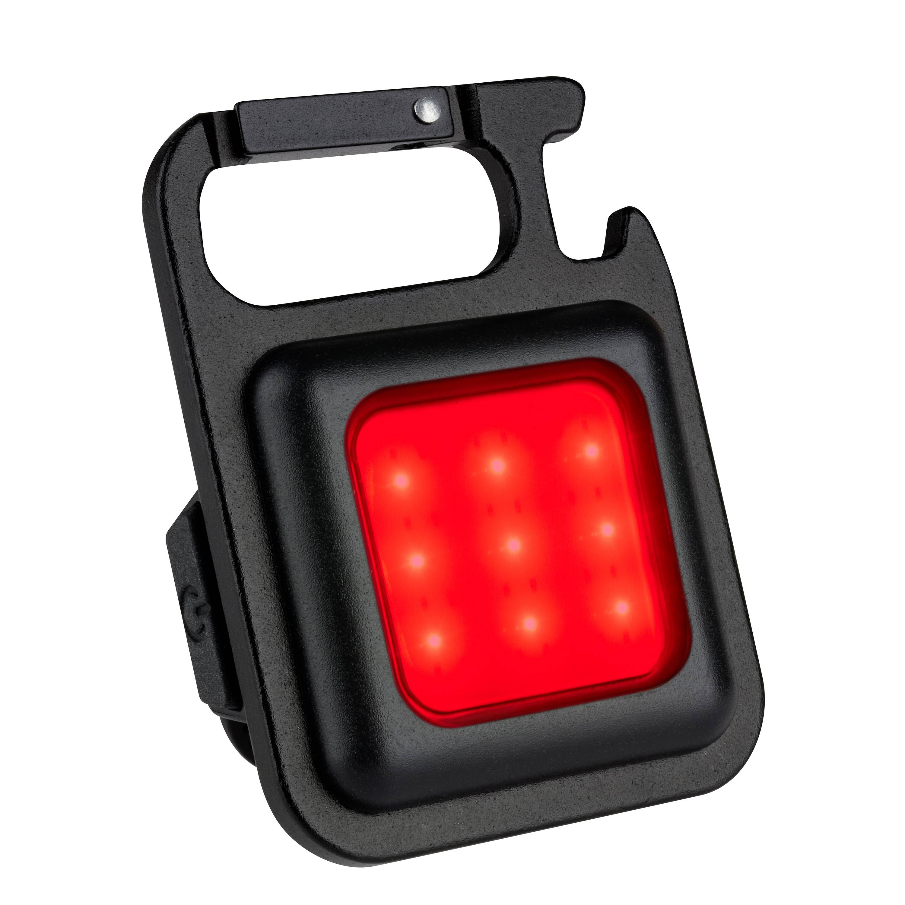 A small, portable LED light cube with red light and nine illuminating points, housed in a black casing with a clip mounting.
