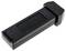 A black electronic device, likely an adapter or connector, with multiple metallic contacts at one end.