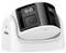 Camera with two lenses in a white casing, suitable for surveillance, placed on a table.