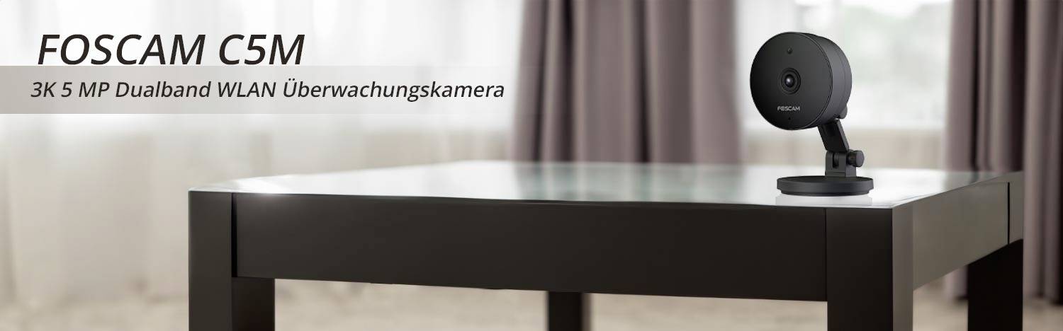 Security camera on a table. Text: 'FOSCAM C5M - 3K 5 MP Dual-Band Wi-Fi Security Camera'.