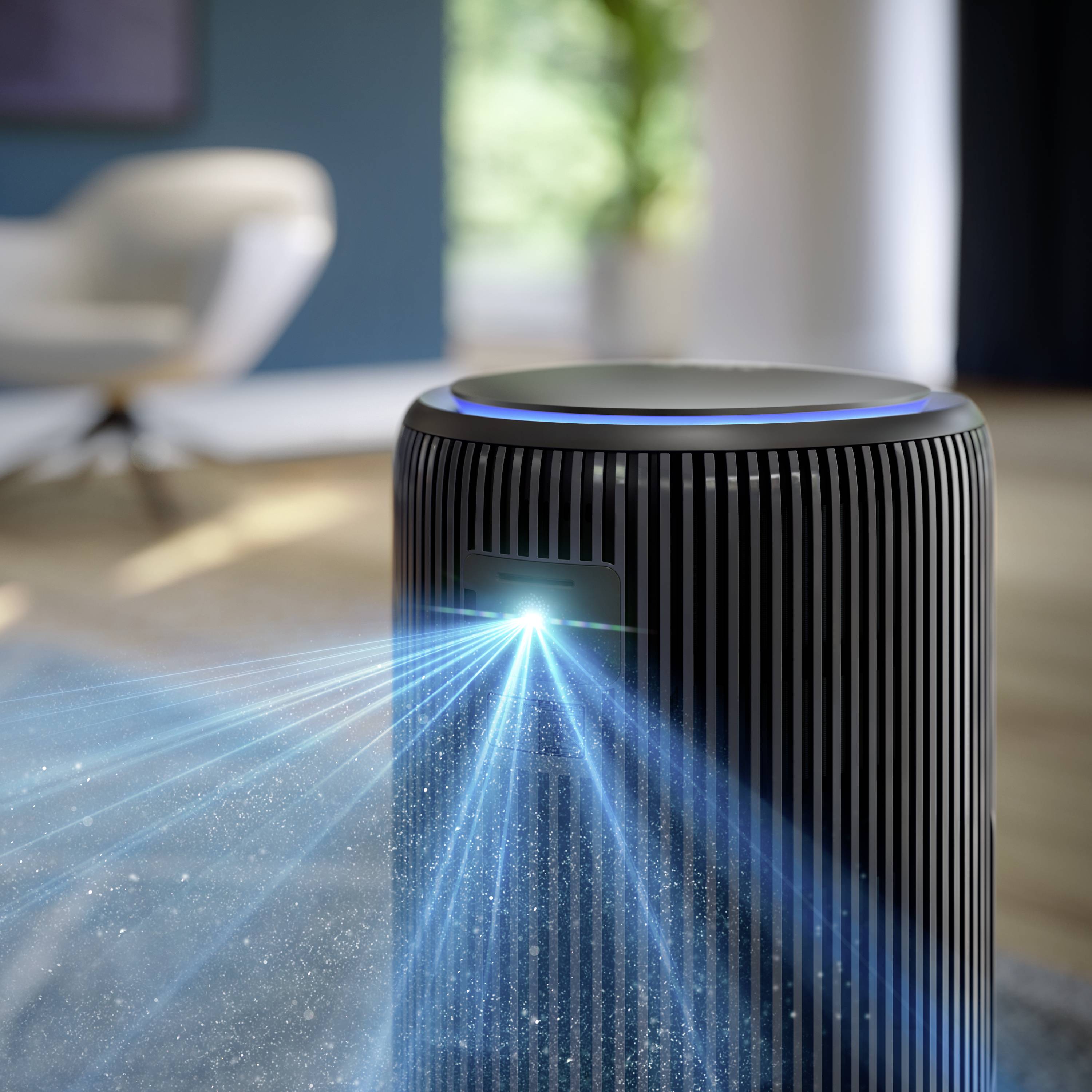 Air purifier in a modern living room, emitting blue light towards the front. Blurred furniture and plants in the background.