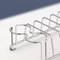 Metal pen holder with a curved design, empty, on a light background. Suitable for organising writing implements.