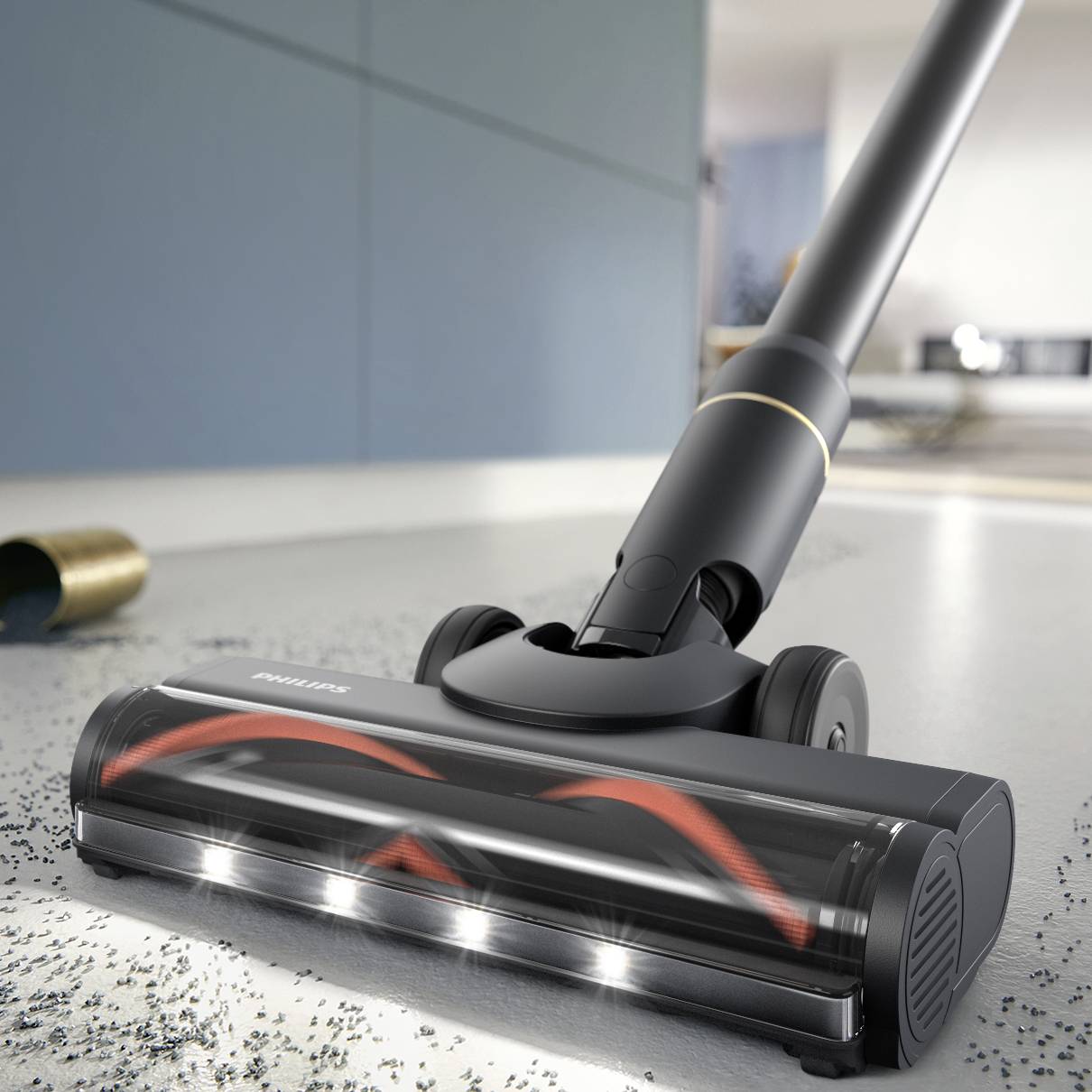 A vacuum cleaner with an illuminated nozzle is cleaning a floor. A blurred room can be seen in the background.