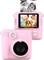 A pink instant camera with a display shows a smiling child with friends. A photo is being printed out at the top.